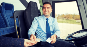 Public transportation driver accepting ticket from passenger
