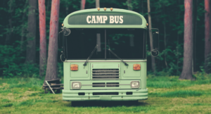 Summer camp bus in the woods waiting for travel.