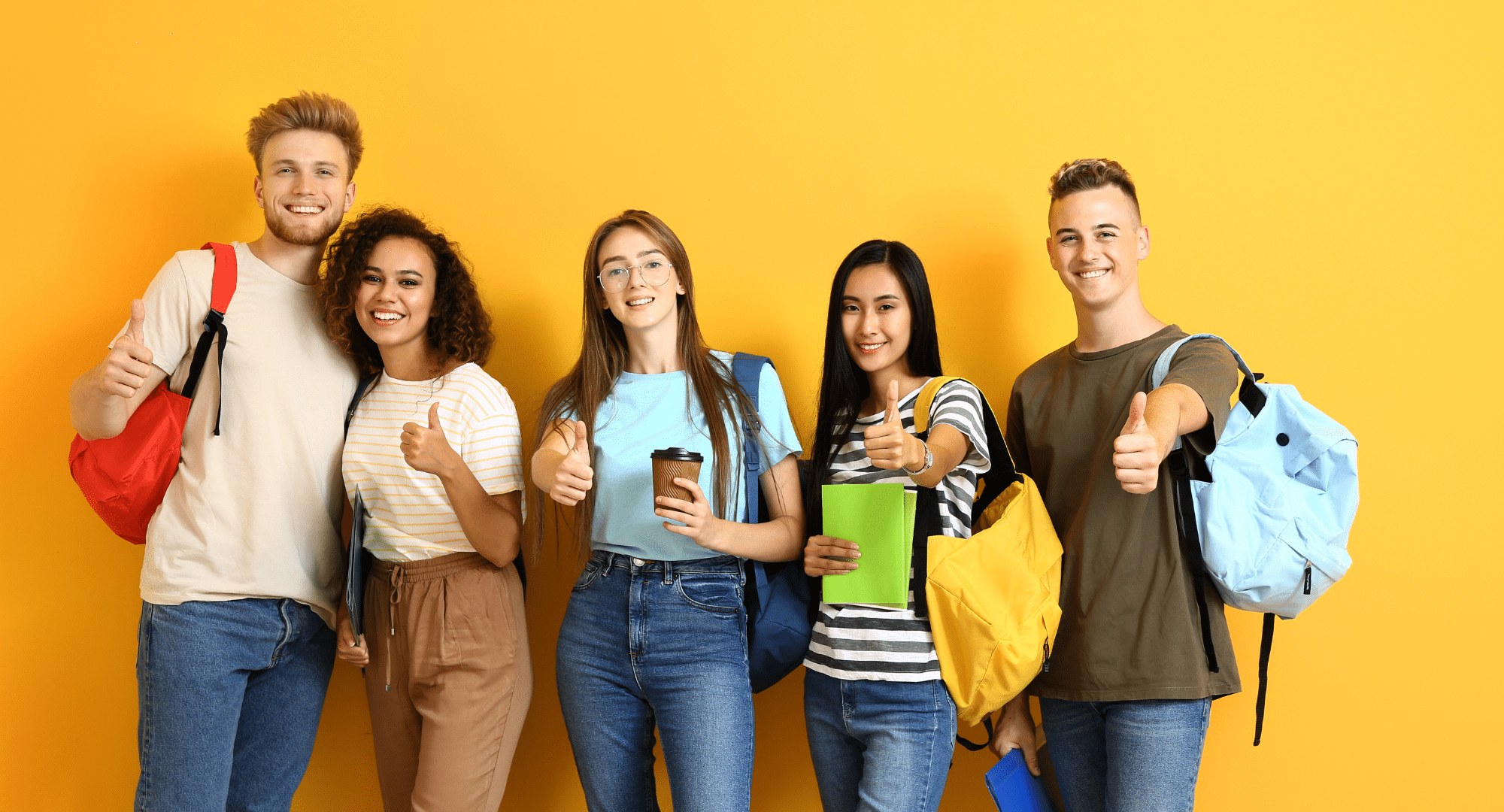 Five college students giving thumbs up.