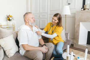 doctor examining man in a home