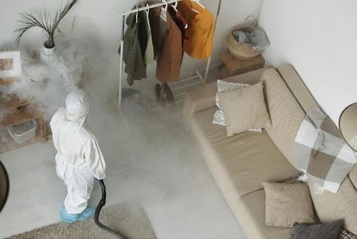 exterminator spraying steam in a home